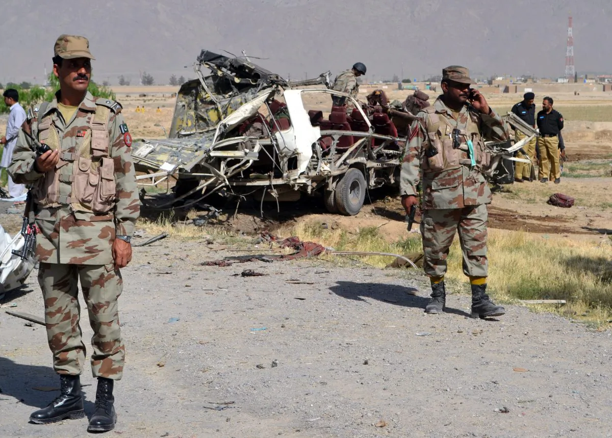 Pakistani security officials keep watch near a destroyed vehicle used by security forces following a bomb attack on the outskirts of Quetta, the capital of restive Baluchistan province, on May 23, 2013. (Banaras Khan/AFP/Getty Images)