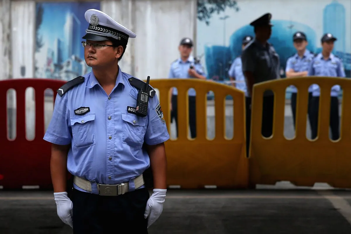 Chinese policemen guard outside the Jinan Intermediate People's Court, on August 25, 2013 in Jinan, China. (Feng Li/Getty Images)