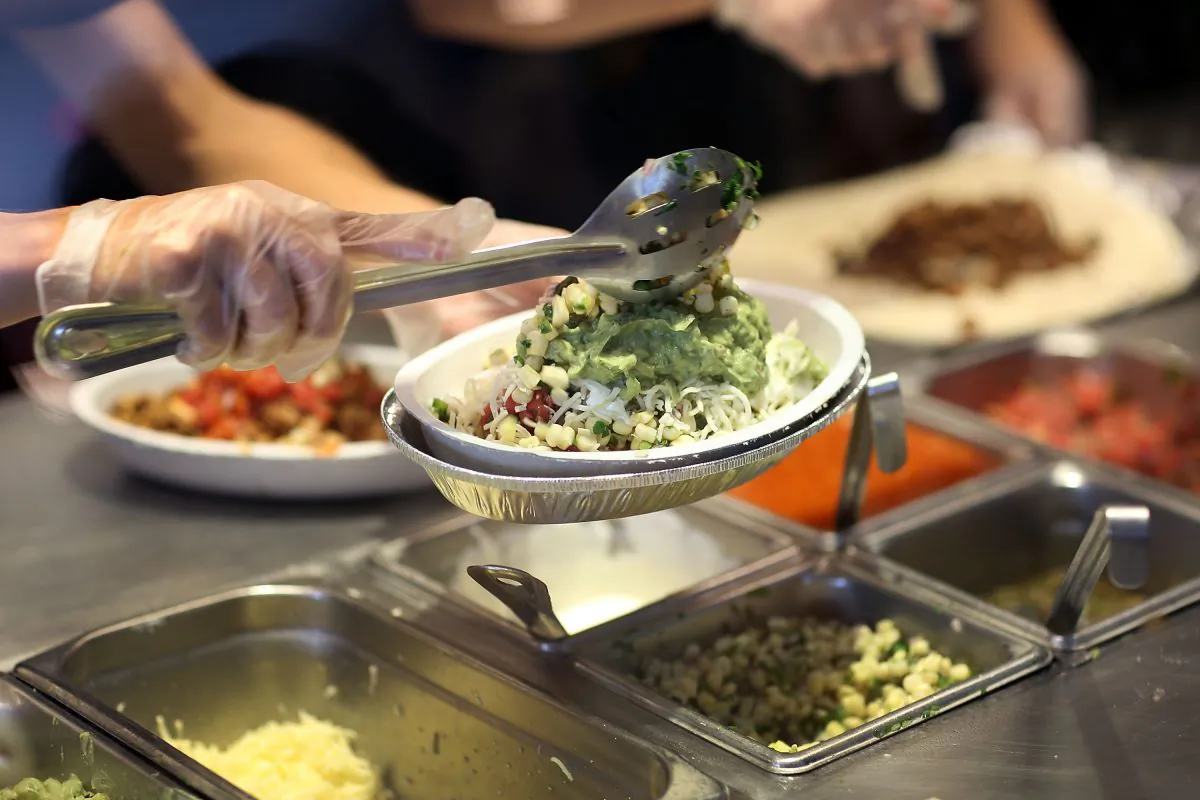 Chipotle restaurant workers fill orders for customers on April 27, 2015 in Miami, Florida. (Photo by Joe Raedle/Getty Images)