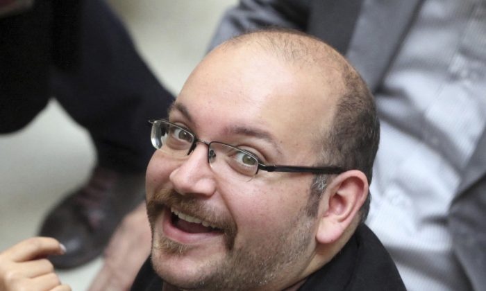 Jason Rezaian, an Iranian-American correspondent for The Washington Post, smiles as he attends a presidential campaign of President Hassan Rouhani in Tehran, Iran. 