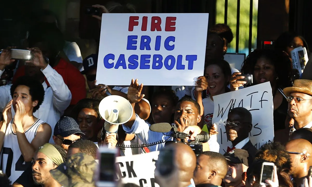 Demonstrators gather near a community pool Monday, June 8, 2015, during a protest in response to an incident at the pool involving McKinney police officers in McKinney, Texas. (AP/Ron Jenkins)