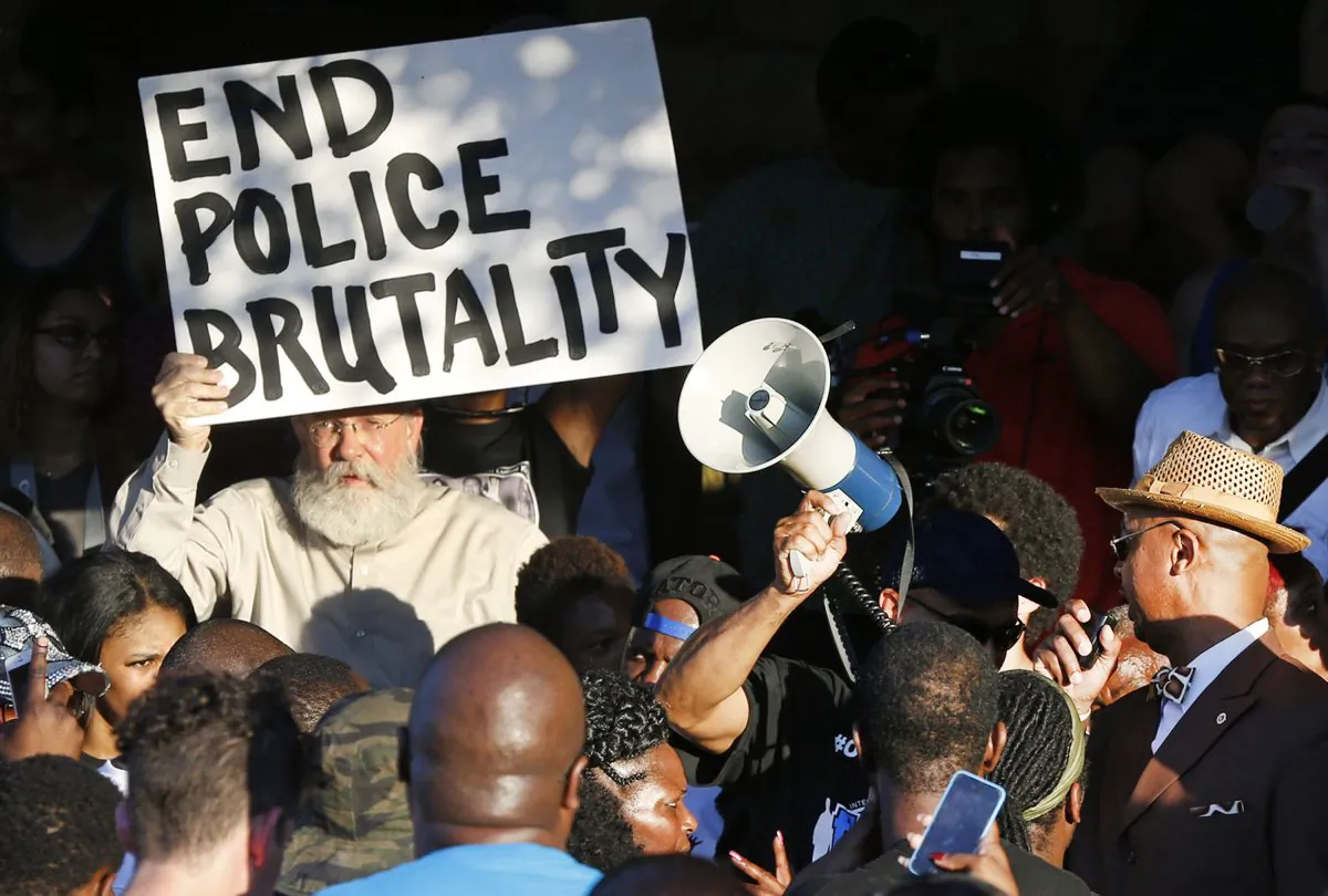 Demonstrators gather near a community pool during a protest Monday, June 8, 2015, in response to an incident at the pool involving McKinney police officers in McKinney, Texas. (AP Photo/Ron Jenkins)