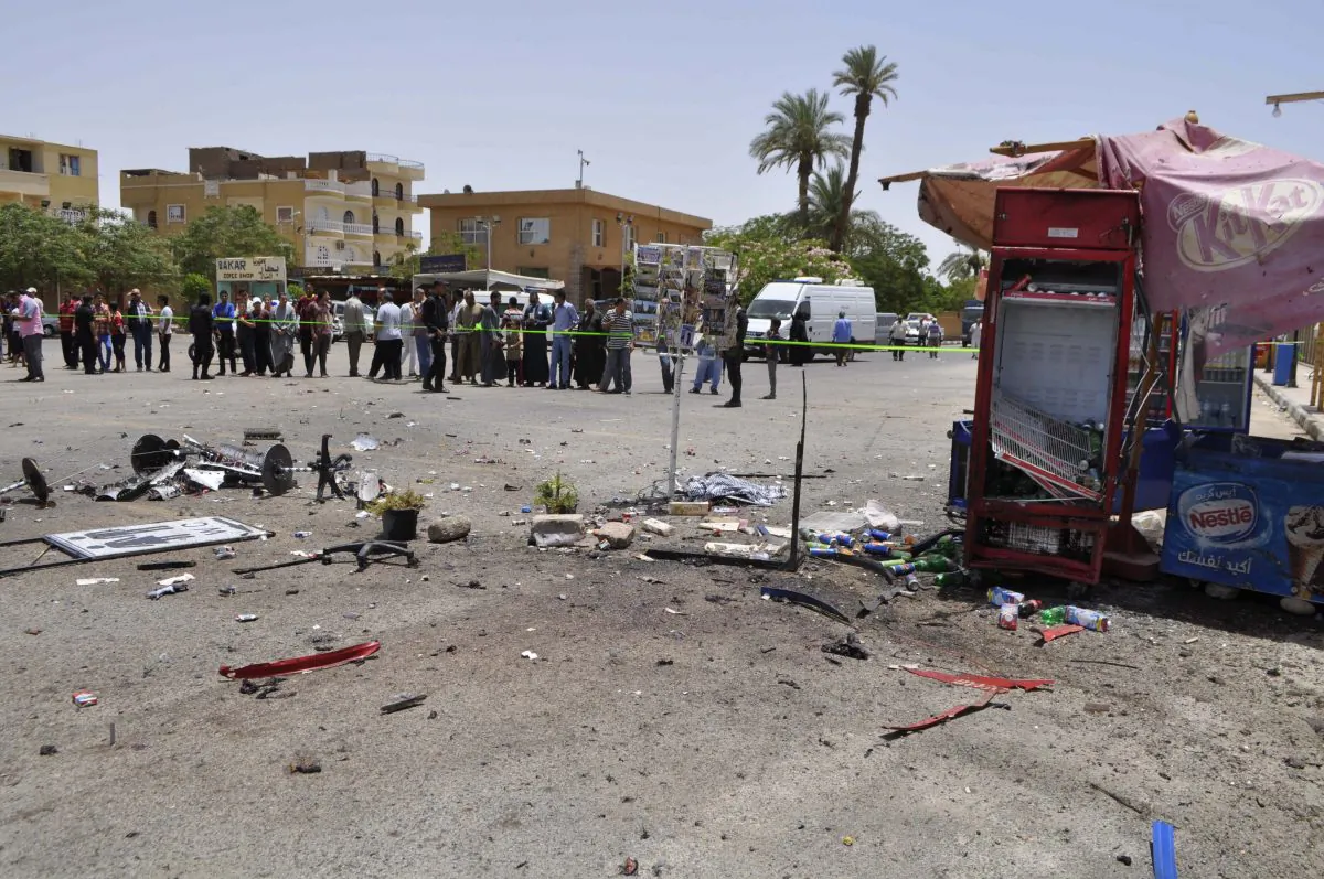 A crowd looks on at the site of a suicide bombing, near Karnak Temple in Luxor, Egypt, Wednesday, June 10, 2015. (AP Photo)