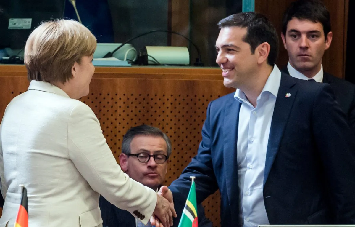 Greek Prime Minister Alexis Tsipras, right, shakes hands with German Chancellor Angela Merkel during a round table meeting at the EU-CELAC summit in Brussels on Wednesday, June 10, 2015. (AP Photo/Geert Vanden Wijngaert)