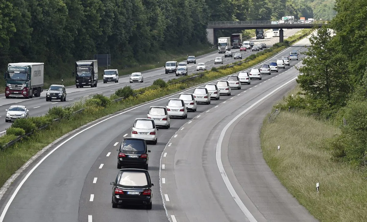 A convoy of hearses drives on the highway in Duisburg, Germany, Wednesday, June 10, 2015, taking home 16 school children who died in the Germanwings plane crash in March. The coffins, that arrived at the airport in Duesseldorf Tuesday evening, are brought to their families in the city of Haltern. (AP/Martin Meissner)