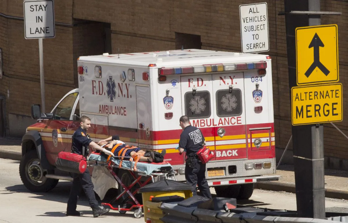 An injured person is carried on a stretcher to an ambulance at the entrance to the Lincoln Tunnel, Wednesday, June 10, 2015 in New York. (AP Photo/Mark Lennihan)