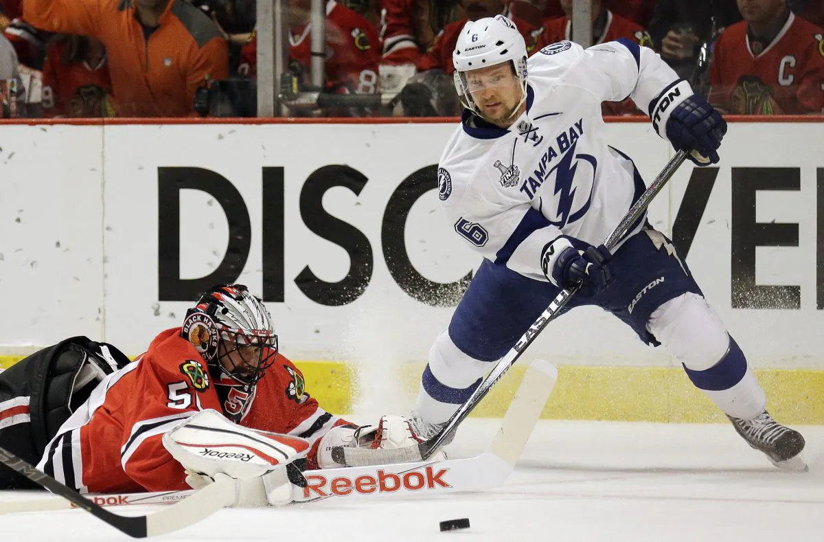 Chicago Blackhawks goalie Corey Crawford, left, and Tampa Bay Lightning's Anton Stralman watch a loose puck during the first period in Game 4 of the NHL hockey Stanley Cup Final Wednesday, June 10, 2015, in Chicago. (AP Photo/Nam Y. Huh)