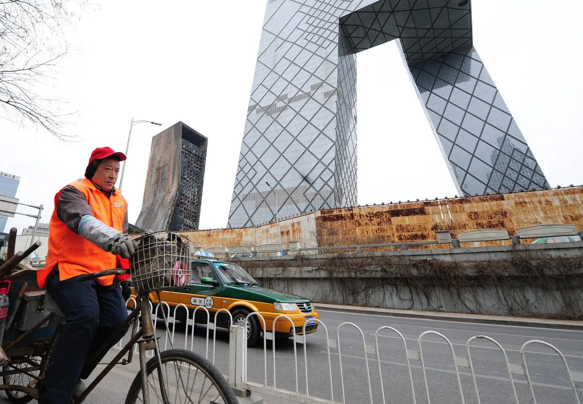 A streetsweeper rides past the CCTV Headquarters in Beijing on February 28, 2010. (FREDERIC J. BROWN/AFP/Getty Images)