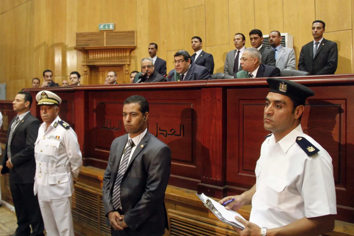 Egyptian Judge Shaaban el-Shami, center, sentences ousted Egyptian President Mohammed Morsi to death over his part in a mass prison break that took place during the 2011 uprising that toppled Hosni Mubarak, in a converted lecture hall in the national police academy in an eastern Cairo suburb, Egypt, Saturday, May 16, 2015. (AP Photo/Ravy Shaker, El Shorouk newspaper)