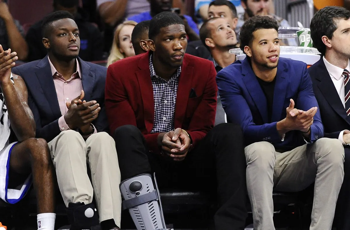 Philadelphia 76ers center Joel Embiid (C), is flanked by teammates Jerami Grant (L) and Michael Carter-Williams. Embiid missed all of the 2014–15 season with a right foot stress fracture. (AP Photo/Michael Perez)