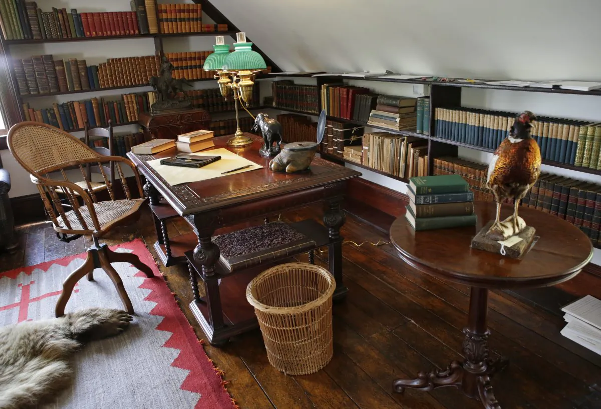 In this June 9, 2015, photo, a third-story alcove in Theodore Roosevelt's "gun room" contains the president's favorite desk, one where he wrote and dictated to his secretary at Sagamore Hill, his summer White House in Oyster Bay, N.Y. (AP Photo/Kathy Willens)