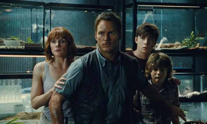 (L to R) Claire (Bryce Dallas Howard), Owen (Chris Pratt), Zach (Nick Robinson) and Gray (Ty Simpkins) watch in terror in "Jurassic World" (Universal Pictures/Amblin Entertainment)
