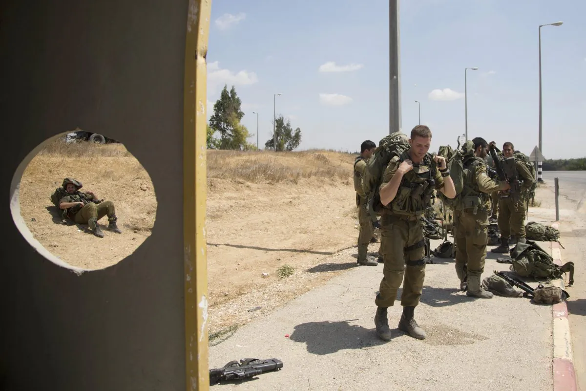  In this Aug. 27, 2014 file photo, Israeli soldiers rest in a bus station near the southern Israeli town of Sderot, next to the Israeli Gaza border. (AP Photo/Oded Balilty)