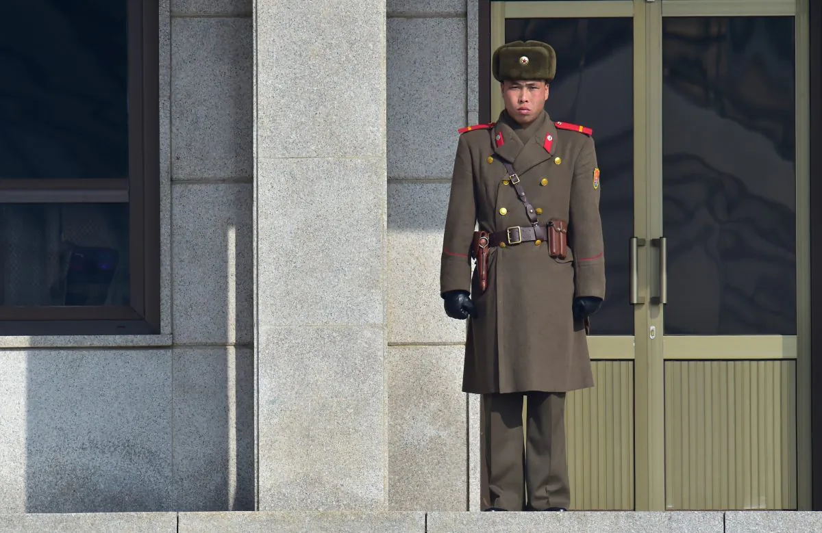A North Korean soldier stands guard at the north side of the truce village of Panmunjon in the demilitarized zone dividing the two Koreas on Feb. 4. A recent poll of North Koreans showed a lot of interest in reunification of North and South Korea. (NJUNG YEON-JE/AFP/Getty Images)
