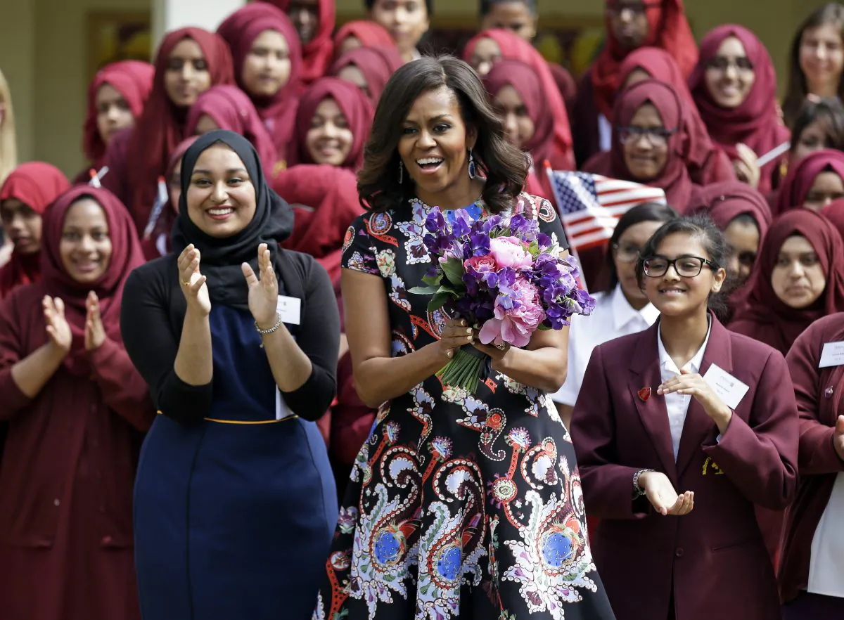 U.S. first lady Michelle Obama is greeted by pupils and teachers at Mulberry School for Girls in east London, Tuesday, June 16, 2015. Michelle Obama is due to meet with female students in London on Tuesday to encourage them to pursue top educational goals. (AP/Matt Dunham)
