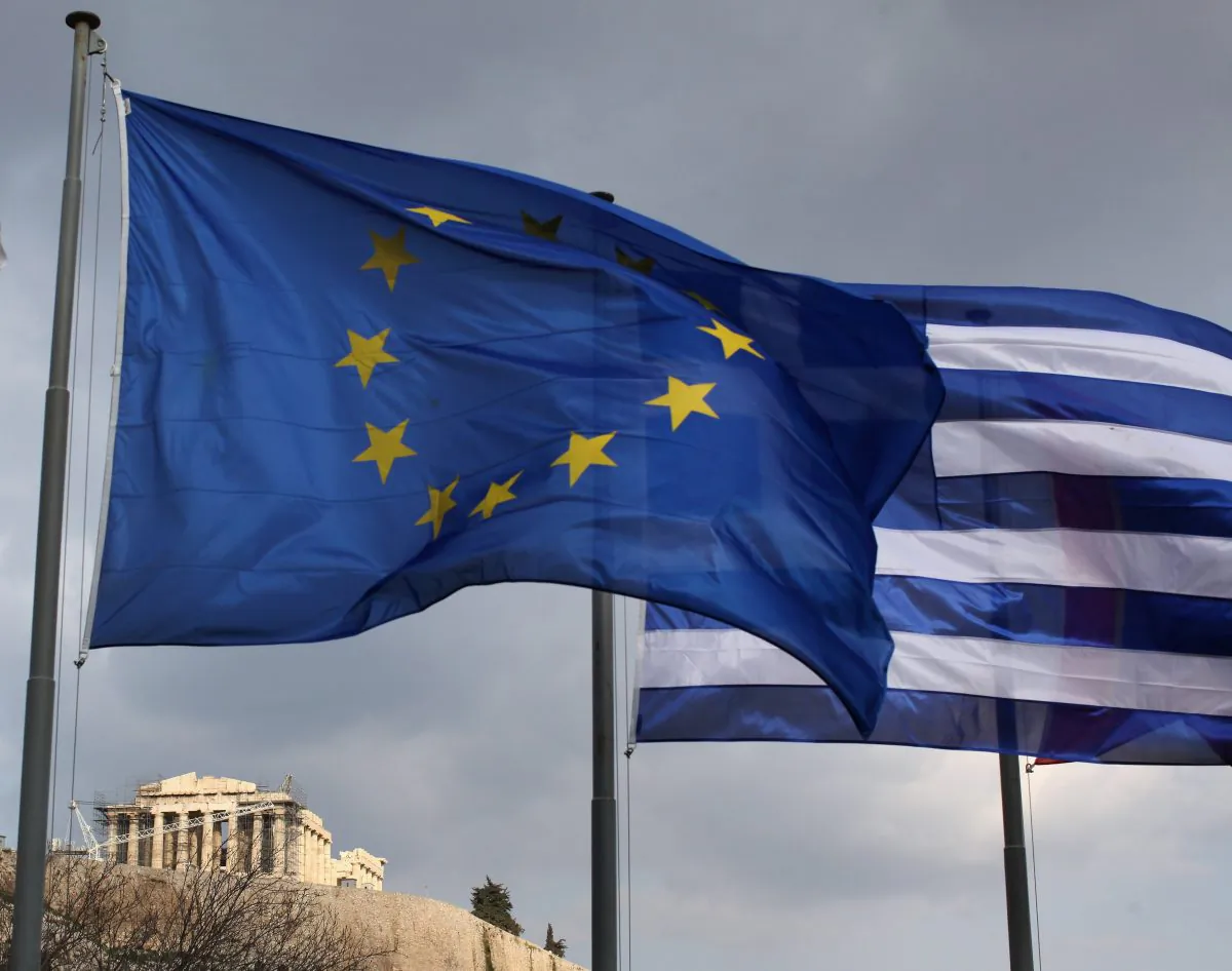 The EU and Greek flags fly in front of the Parthenon on the Acropolis on February 17, 2012 in Athens, Greece. (Oli Scarff/Getty Images)