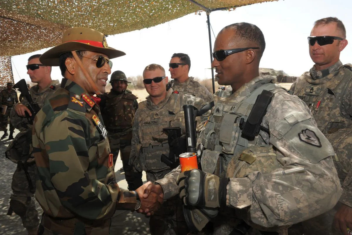 Indian army commander Lt. Gen. Gyan Bhushan (L) greets U.S. soldiers participating in a military exercise in Mahajan, India’s northwestern state of Rajasthan, on March 13, 2012. (Sam Panthaky/AFP/Getty Images)
