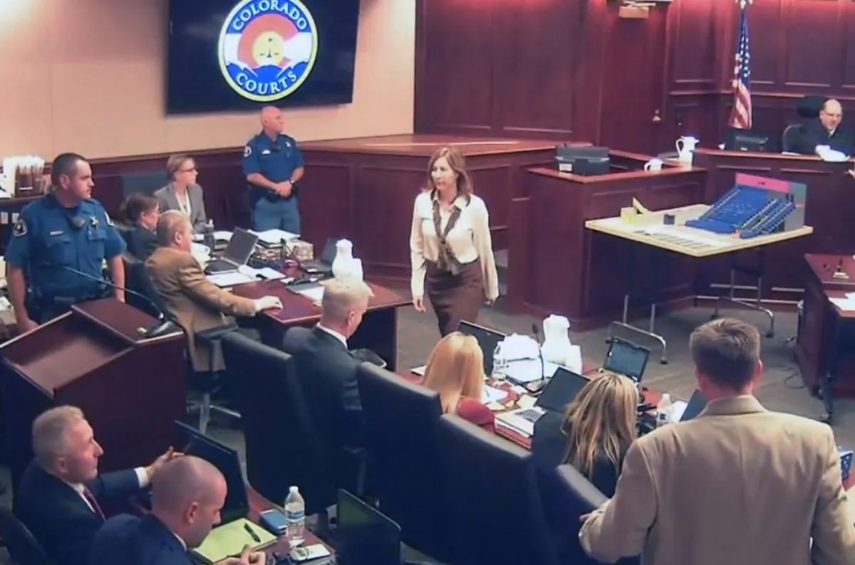 In this image taken from video, Colorado theater shooter James Holmes' former psychiatrist Dr. Lynne Fenton, center, exits the courtroom after testifying in the Holmes trial, in Centennial, Colo., Tuesday, June 16, 2015. (Colorado Judicial Department via AP, Pool)
