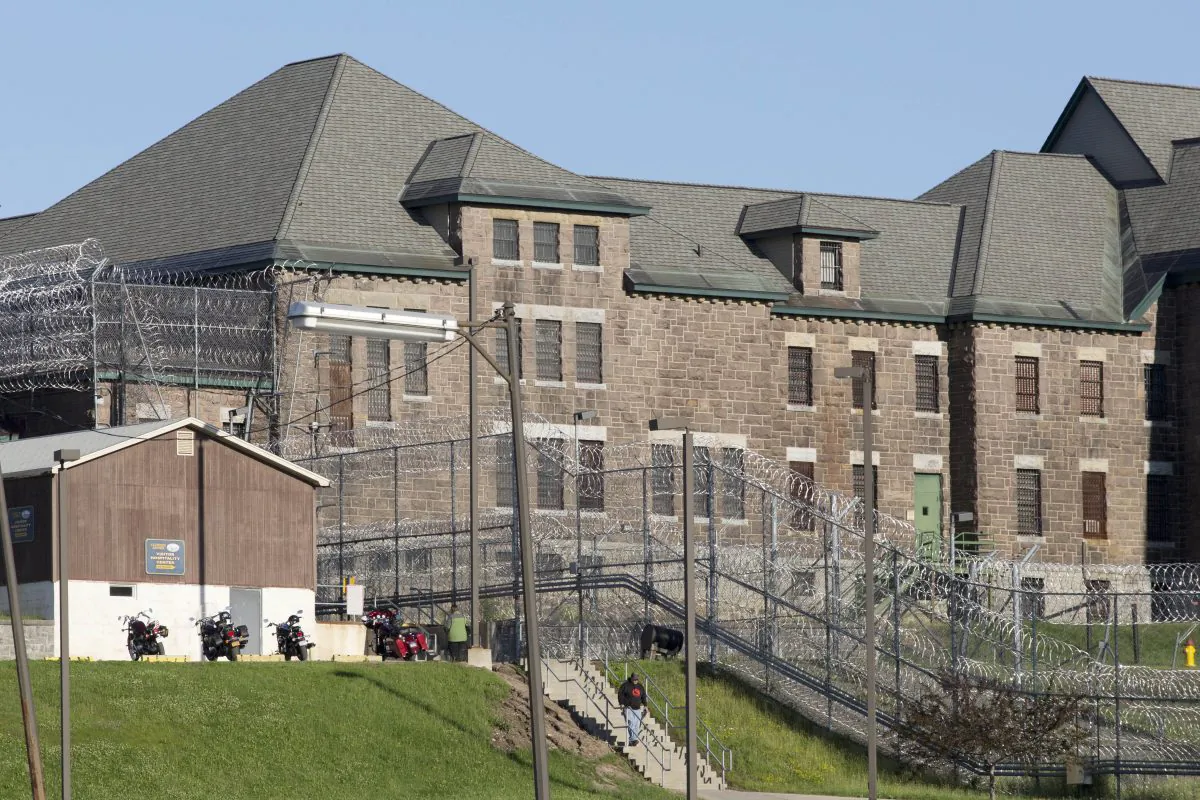 An employee leaves the Clinton Correctional Facility, Wednesday, June 17, 2015 in Dannemora, N.Y. Search teams are back in the woods of northern New York looking for two convicted murderers who broke out of the maximum-security prison a week and a half ago. More than 800 law enforcement officers are in the 12th day of searching for David Sweat and Richard Matt. (AP/Mark Lennihan)