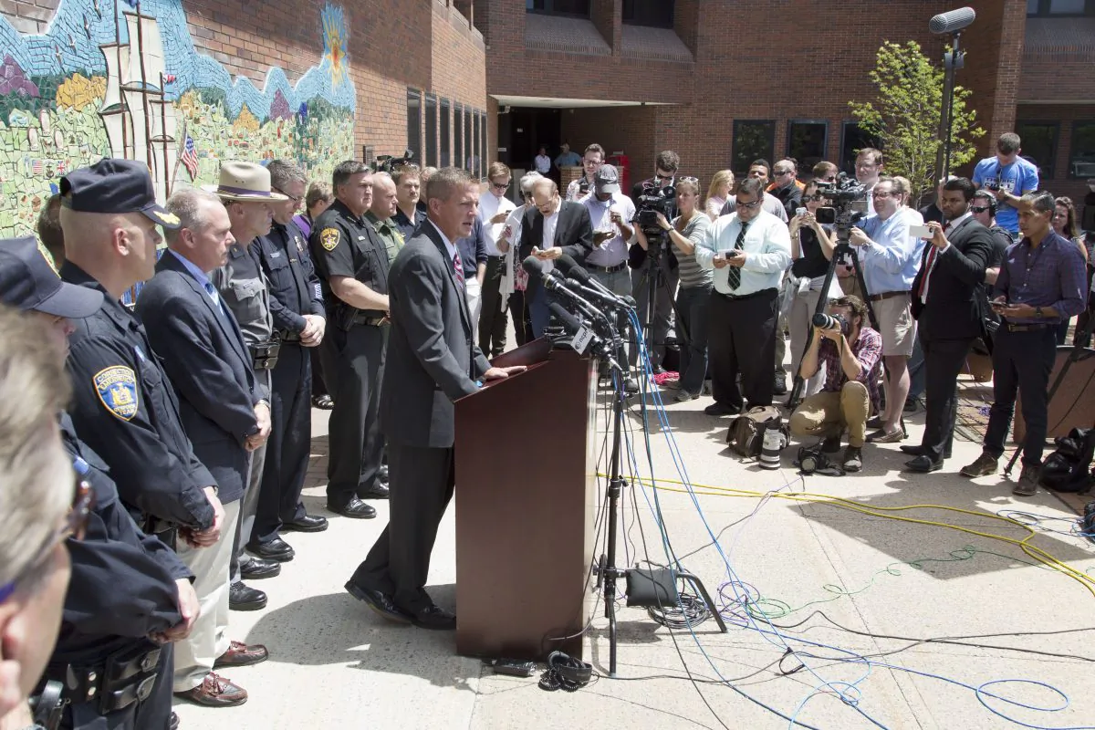 Clinton County District Attorney Andrew Wylie (C) discusses the escape of two prisoners, during a news conference, Wednesday, June 17, 2015 in Plattsburgh, N.Y. (AP Photo/Mark Lennihan)