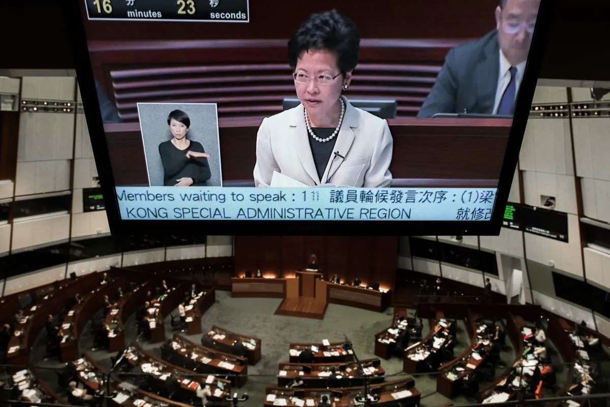 A TV screen shows Hong Kong Chief Secretary Carrie Lam as she addresses the city's legislature in Hong Kong on June 17, 2015. (Philippe Lopez/AFP/Getty Images)