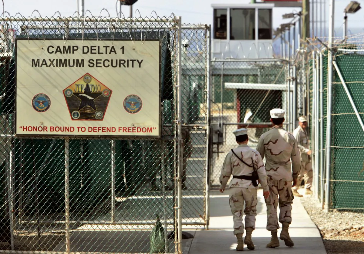 U.S. military guards walk within Camp Delta military-run prison, at the Guantanamo Bay U.S. Naval Base, Cuba, on June 2, 2006. (AP Photo/Brennan Linsley)