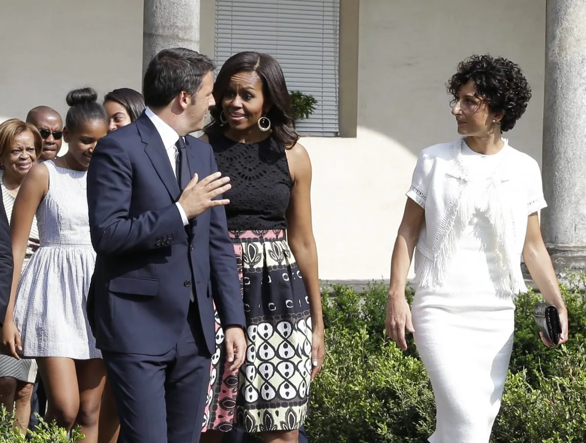 U.S. first lady Michelle Obama talks with Italian premier Matteo Renzi as she arrives at the Santa Maria delle Grazie church to see Leonardo's masterpiece "The Last Supper", after participating in a cooking demonstration at the James Beard American Restaurant with Italian and American middle school students in Milan, Italy, Wednesday, June 17, 2015.  At right is Renzi's wife Agnes, while behind are Michelle's daughters Malia and Sasha and her mother Marian Robinson. Michelle Obama is in Milan on the second leg of a European trip that puts an international spin on her core initiatives. (AP/Antonio Calanni)