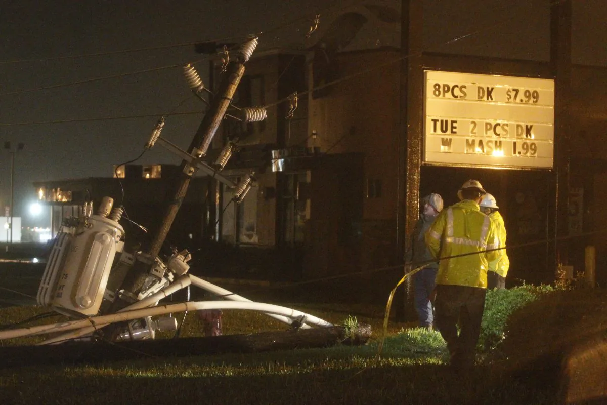 Center Point crews work to restore power after a power line fell on Highway 60 due to high winds from Tropical Storm Bill on Tuesday, June 16, 2015, in Wharton, Texas. (AP/Patric Schneider)