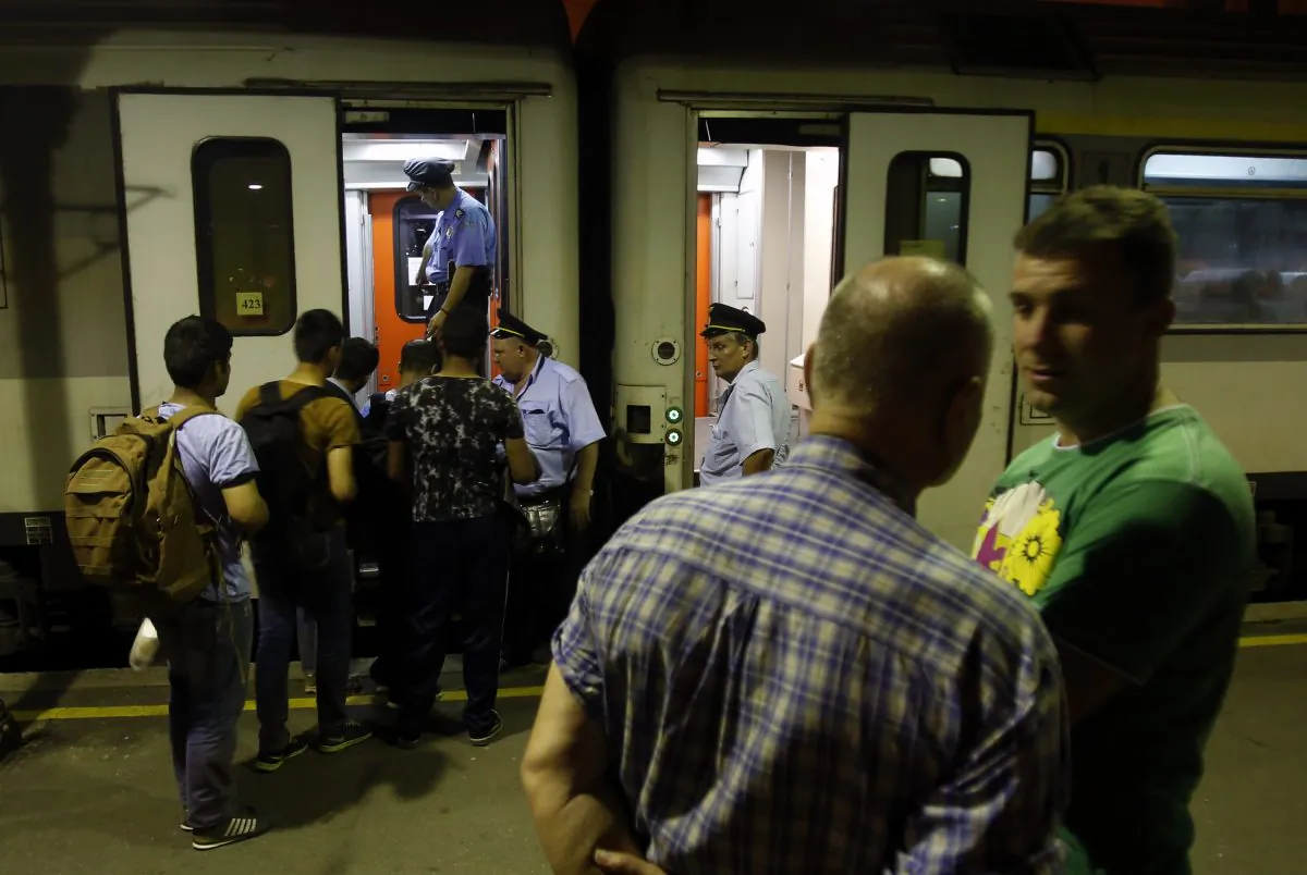 In this photo taken Tuesday, June 2, 2015, migrants getting on the train for Northern Serbian town of Subotica, near the Hungarian border, in Belgrade, Serbia. (AP Photo/Darko Vojinovic)