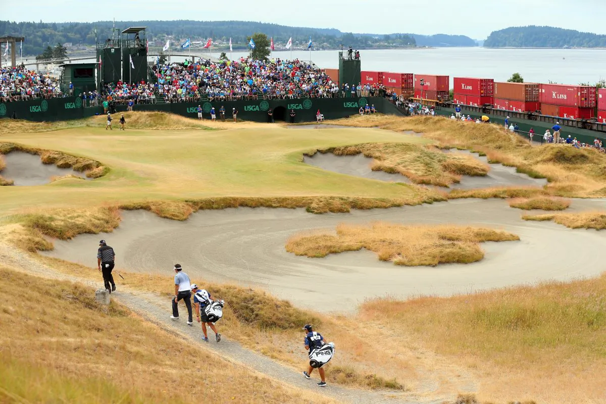 Angel Cabrera of Argentina and Bubba Watson of the United States walk to the 17th green with their caddies during the first round of the 115th U.S. Open Championship at Chambers Bay on June 18, 2015 in University Place, Washington. (Andrew Redington/Getty Images) 