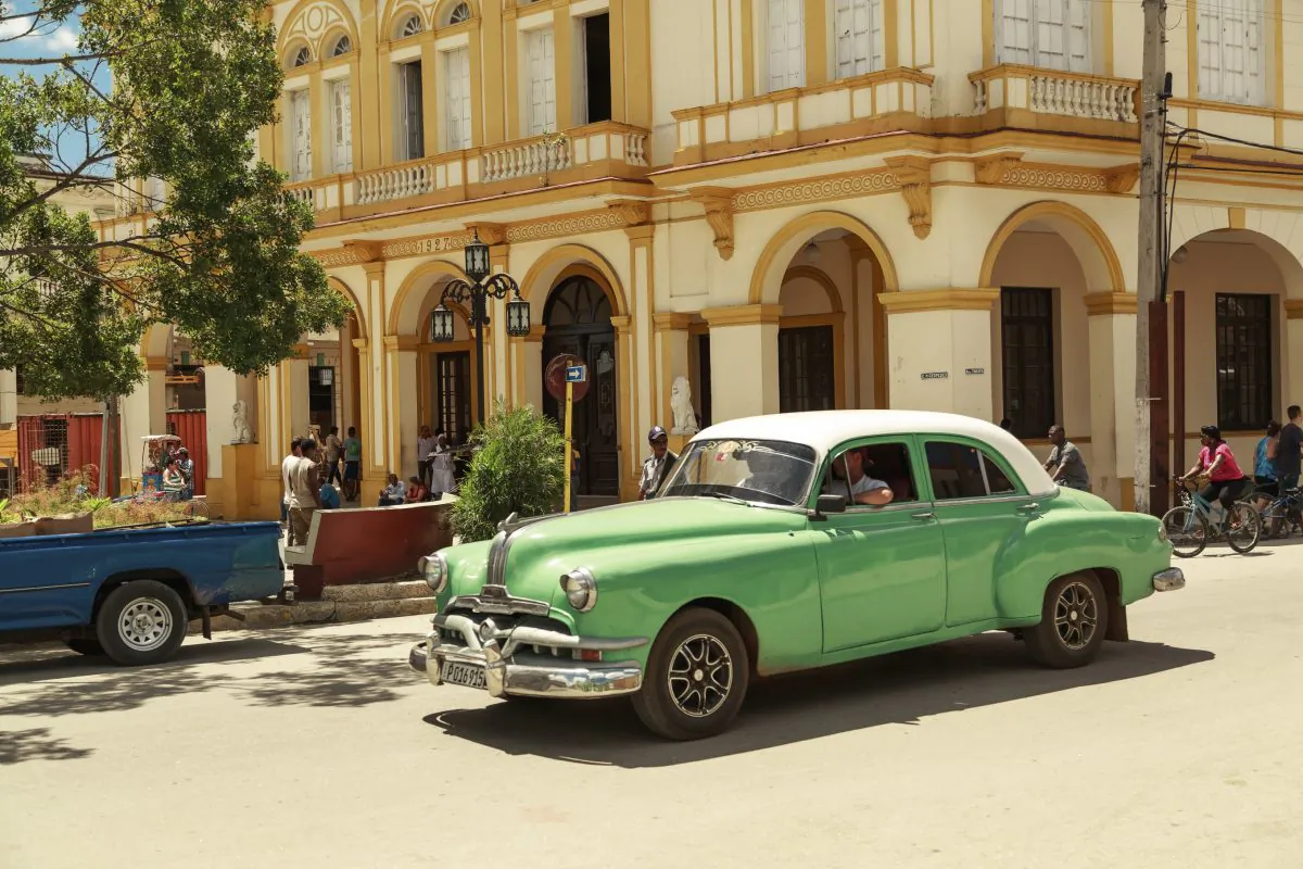 Beautiful green retro car in cuban town. (Vitaldrum/iStock)