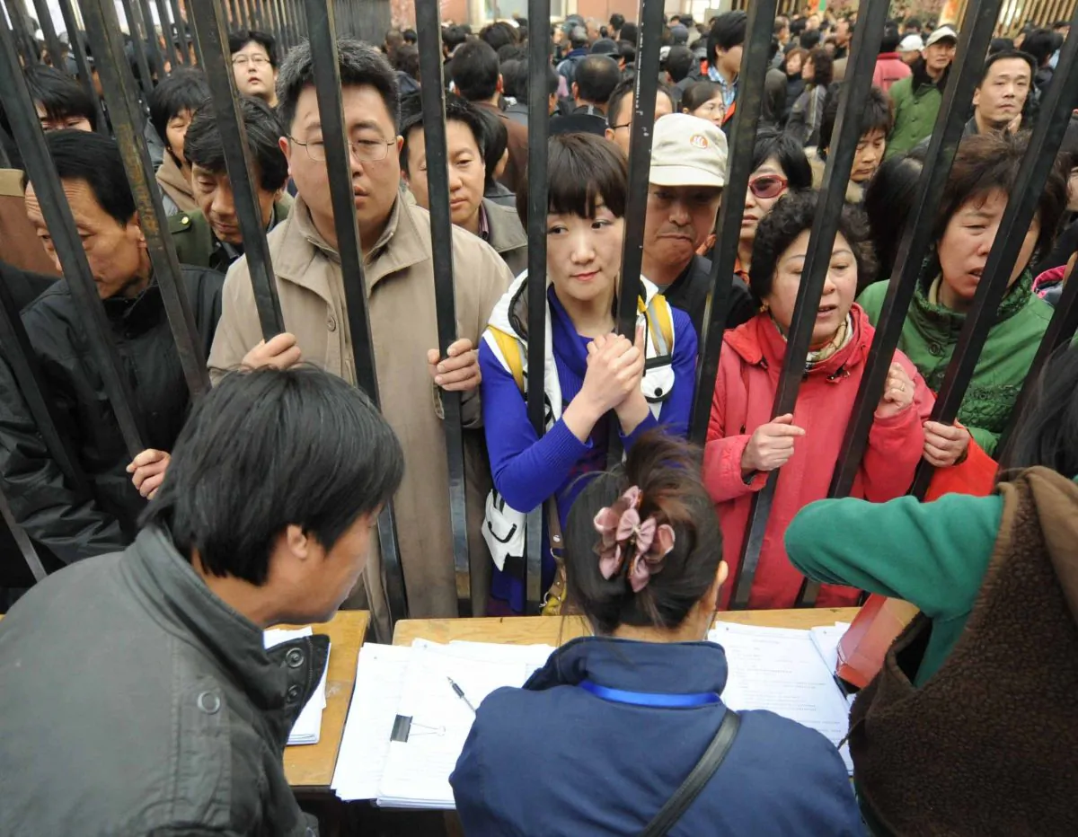 People queue to get better numbers on a waiting list for new apartments after the local government announced the demolition of an old central part of Tongzhou, in the western suburbs of Beijing on April 8, 2010. (STR/AFP/Getty Images)