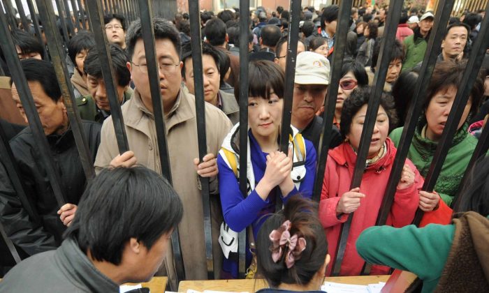 People queue to get better numbers on a waiting list for new apartments after the local government announced the demolition of an old central part of Tongzhou, in the western suburbs of Beijing on April 8, 2010. (STR/AFP/Getty Images)