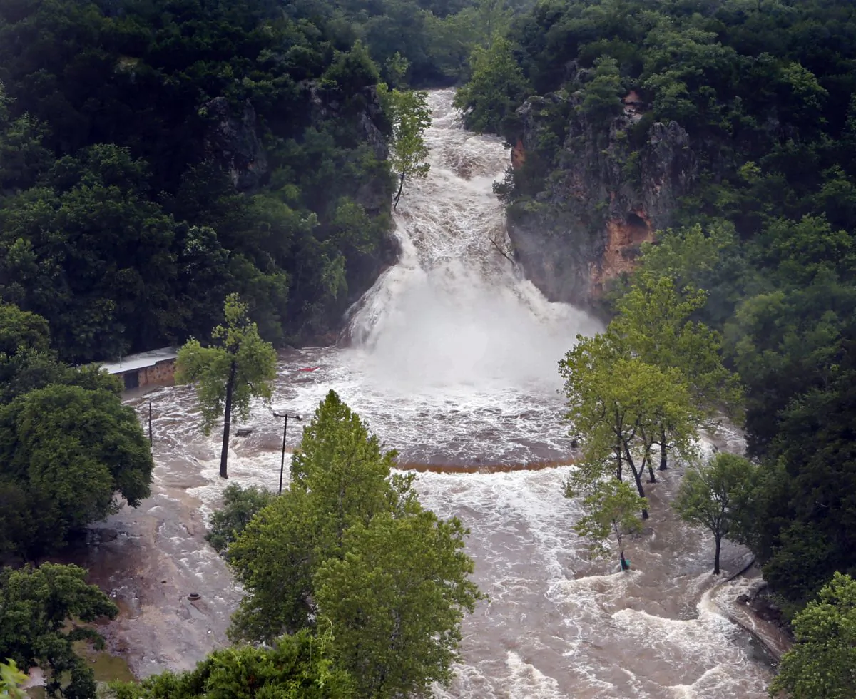 Water pours over Turner Falls and floods the park below in Davis, Okla., on Thursday. (Steve Sisney/The Oklahoman via AP)