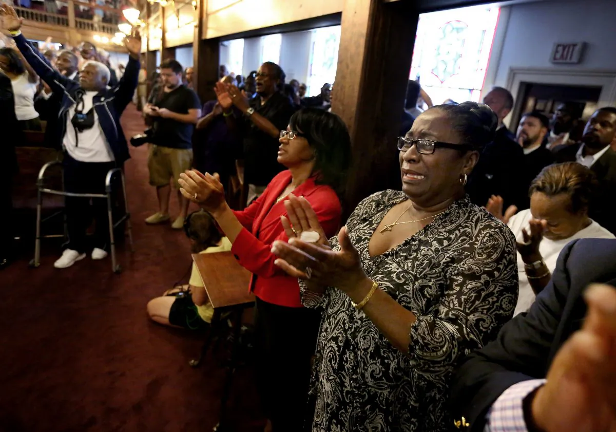 Rev. Jeannie Smalls, right, cries during a prayer vigil held at Morris Brown AME Church for the victims of Wednesday's shooting at Emanuel AME Church on Thursday, June 18, 2015 in Charleston, S.C.   (Grace Beahm/The Post And Courier via AP)