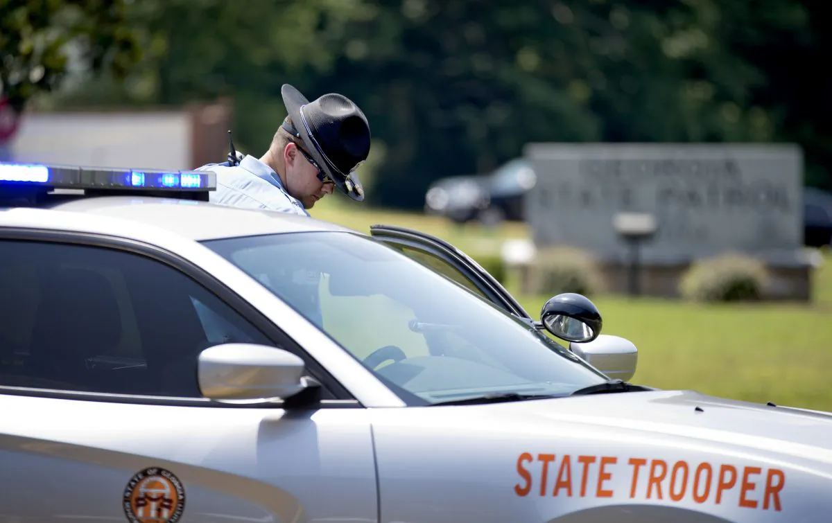 A trooper stands near the scene where one person was shot at a Georgia State Patrol post Monday, June 8, 2015, in Gainesville, Ga. (AP Photo/David Goldman)