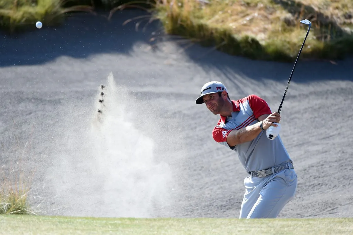 Dustin Johnson hits a shot from a bunker on the 13th hole during the third round of the 115th U.S. Open Championship at Chambers Bay on June 20, 2015 in University Place, Washington. (Harry How/Getty Images) 