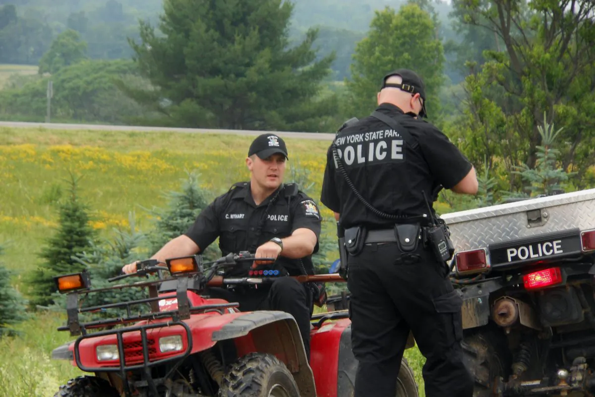Authorities speak to one another during a search for two prisoners that escaped Clinton Correctional Facility two weeks prior, Saturday, June 20, 2015, in Allegany County, N.Y. (Kathryn Ross/The Wellsville Reporter via AP)
