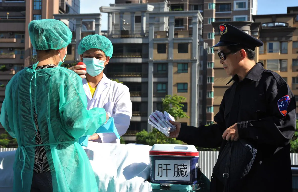 Falun Gong practitioners act out a scene of stealing human organs to sell during a demonstration in Taipei on July 20, 2014. (Mandy Cheng/AFP/Getty Images)