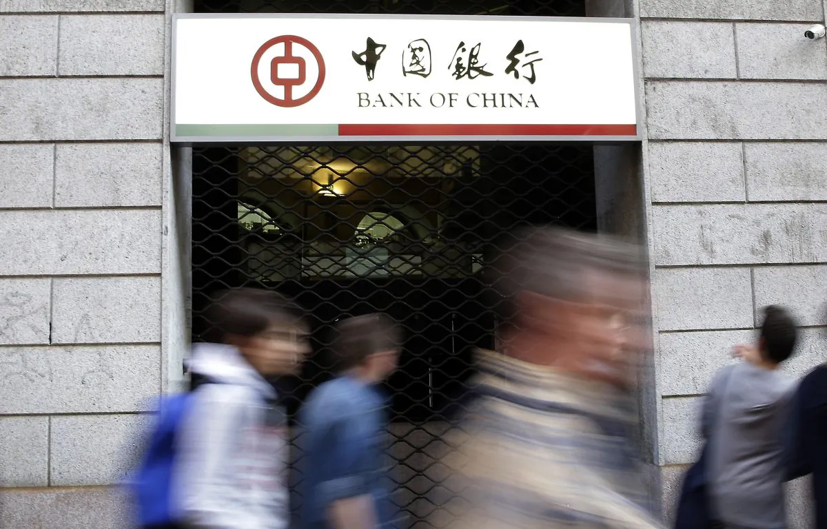 Residents walk past the Bank of China branch in downtown Milan, Italy, on April 15. Italian prosecutors are seeking to indict over 200 people and the Bank of China in connection with a massive money-laundering investigation. (AP Photo/Antonio Calanni, File)