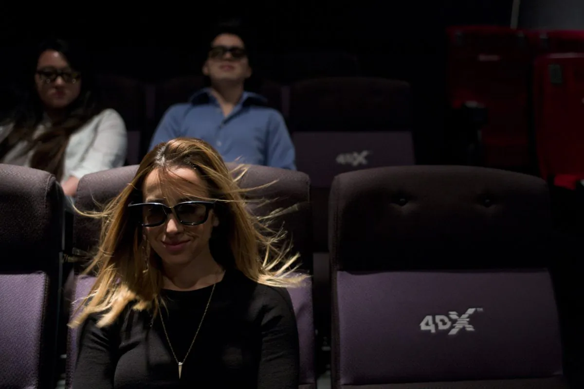  A wind effect is demonstrated on marketing director Yassamine Wahab at the CJ's 4DX Lab in the Hollywood Section of Los Angeles. (AP Photo/Jae C. Hong)