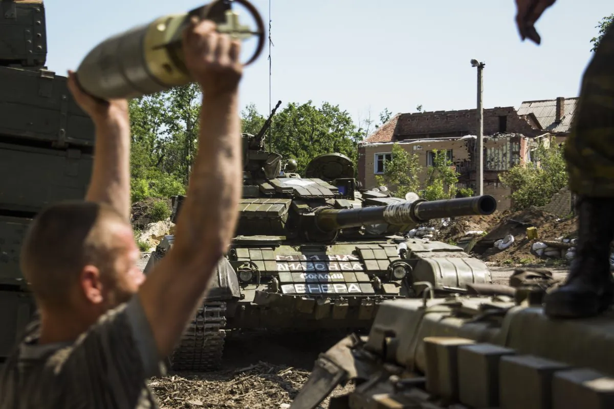 A Russia-backed rebel loads shells into a tank at Donetsk airport, eastern Ukraine, on June 12, 2015. (Mstyslav Chernov/AP Photo)