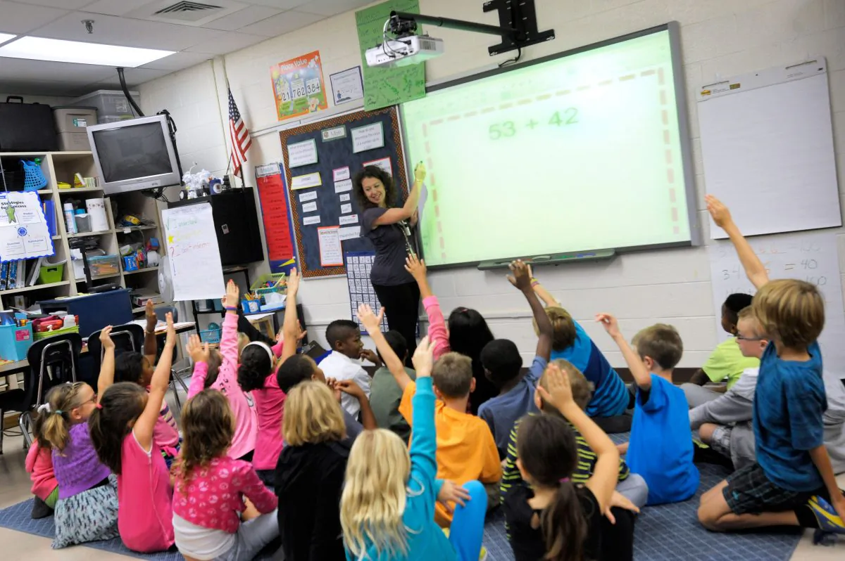 Third grade teacher Melissa Grieshober teaches a math lesson at Silver Lake Elementary School in Middletown, Del., on Oct. 1, 2013. (AP Photo/Steve Ruark)