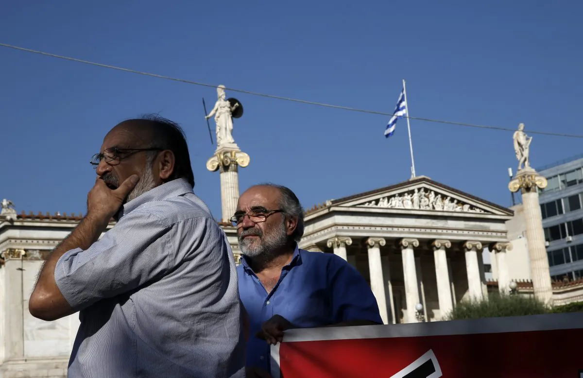 Elderly men take part in an anti-austerity protest organized by pensioners' unions in Athens on Tuesday, June 23, 2015. (AP Photo/Petros Giannakouris)