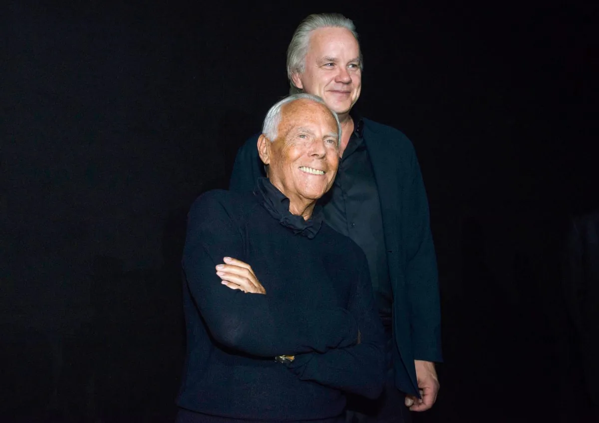 Giorgio Armani (Front) and actor Tim Robbins greets the audience after presenting the Emporio Armani Spring/Summer 2016 men's fashion collection, in Milan on June 20, 2015. (AP Photo/Giuseppe Aresu)