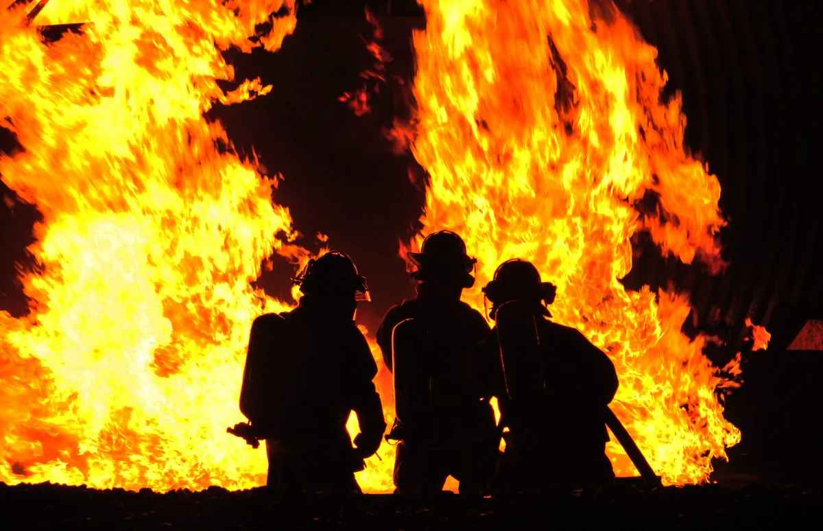 Firefighters fight a controlled fire Oct. 9, 2014, at Misawa Air Base, Japan. The live fire demonstration, hosted by the 35th Civil Engineer Squadron, allowed friends and family members to be educated and entertained as part of fire prevention week. (U.S. Air Force photo/Senior Airman Jose L. Hernandez-Domitilo)