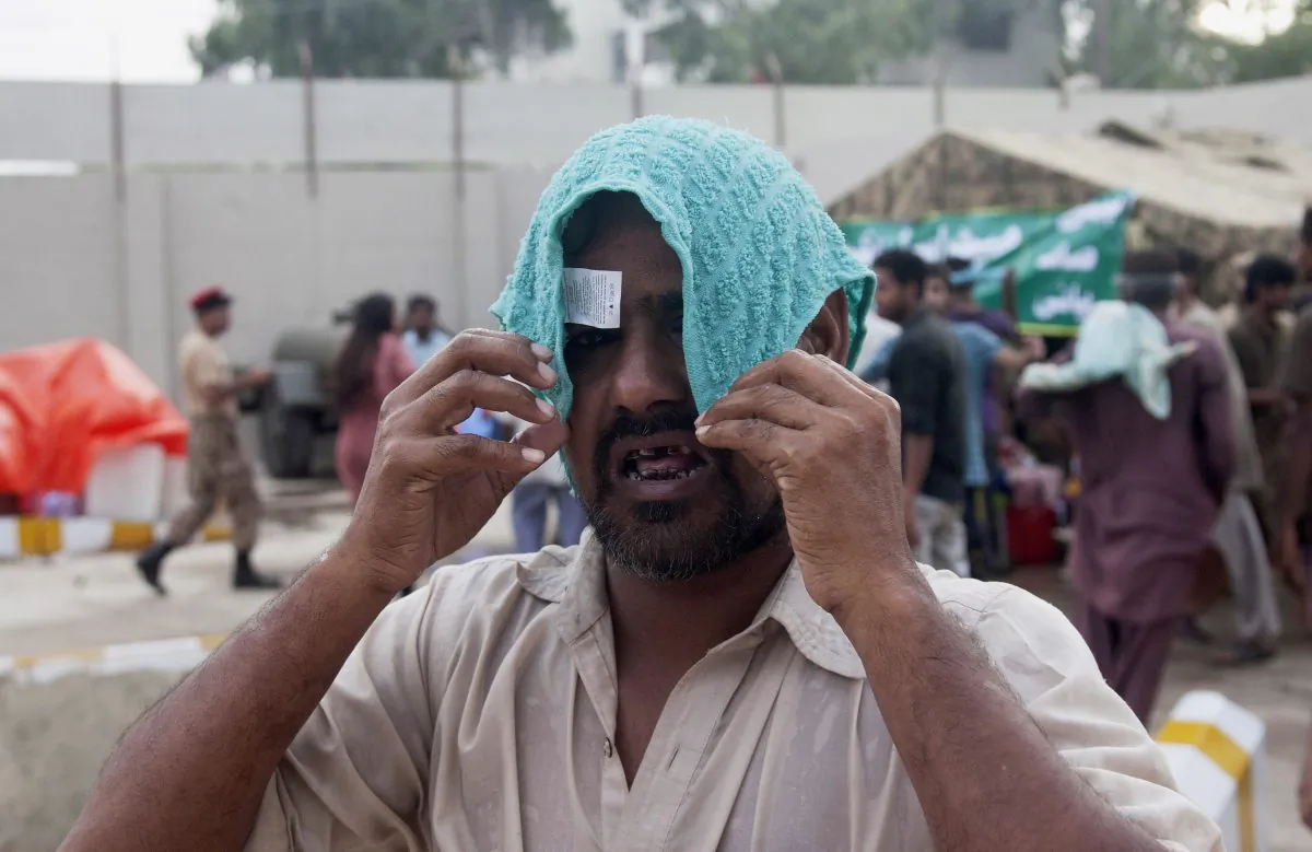 A man covers his head with a wet towel to avoid heatstroke in Karachi, Pakistan, on June 24, 2015.   (Shakil Adil/AP Photo)