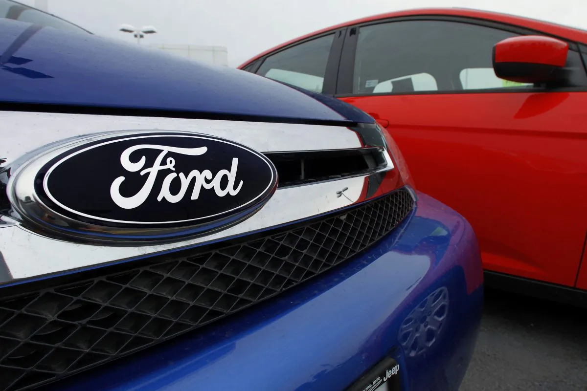FILE - This July 1, 2012 file photo shows the Ford logo on a vehicle at a Ford dealership in Springfield, Ill. (AP Photo/Seth Perlman, File)