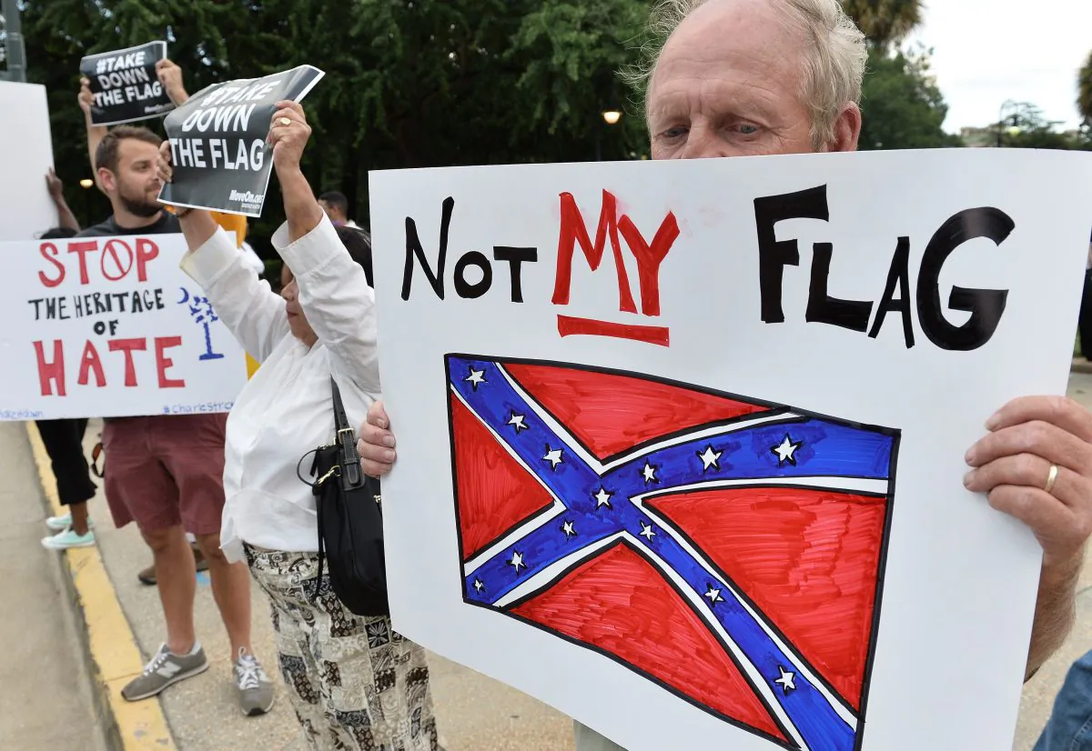 A man holds a sign up during a protest rally against the Confederate flag in Columbia, South Carolina on June 20, 2015. (MLADEN ANTONOV/AFP/Getty Images)