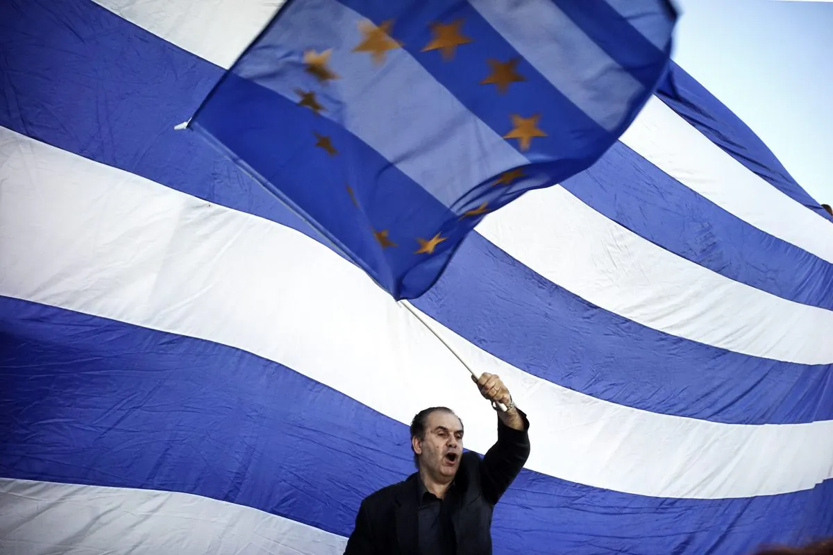 A man waves a EU flag as pro-Euro protesters take part in a rally in front of the Parliament on June 22.  2015 in Athens, Greece. (Milos Bicanski/Getty Images)